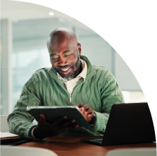 a male business owner in a green shirt reviewing multi-channel data on lead conversion