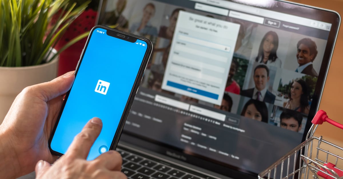 image of someone using linkedin on their phone and computer